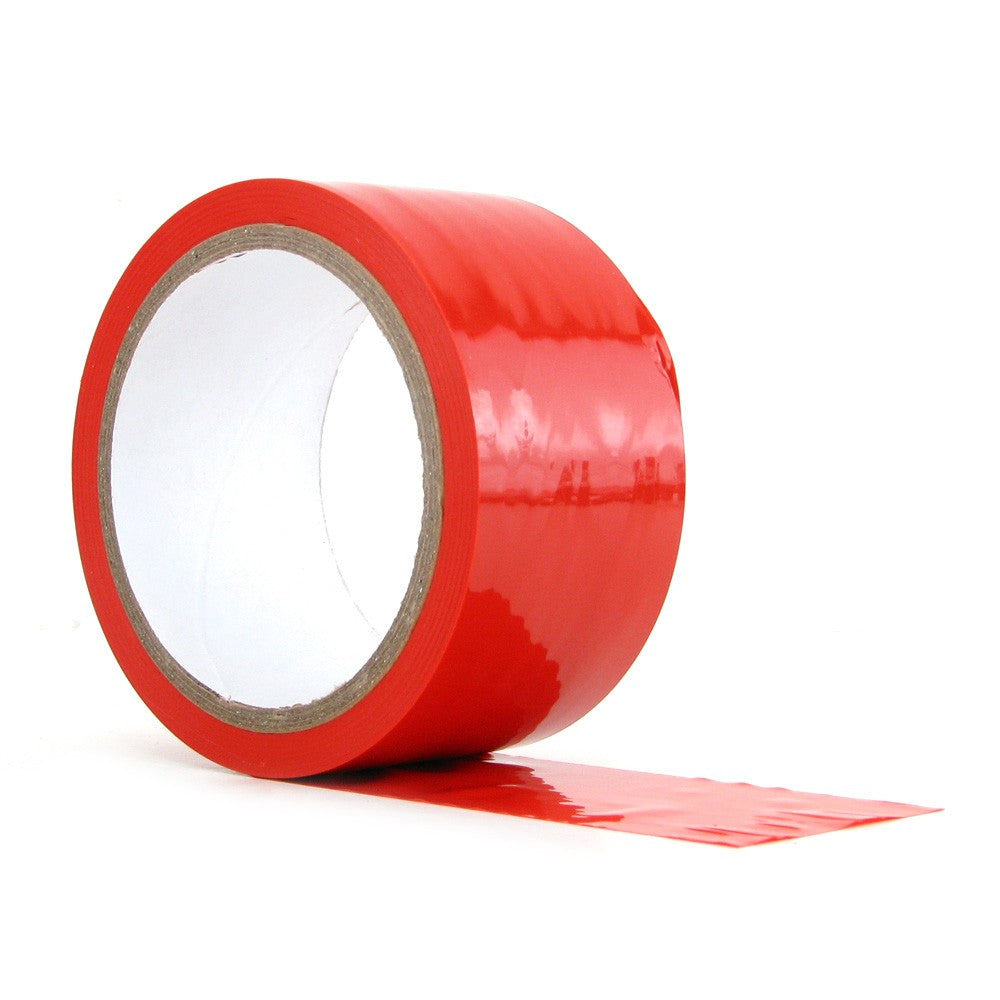 Red PVC tease tape on a roll with a strip of tape extending from it.