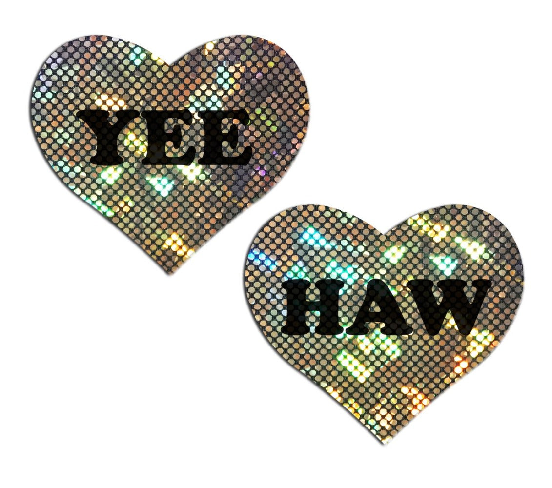 Two heart-shaped nipple pasties with "YEE" and "HAW" text on gold glitter.