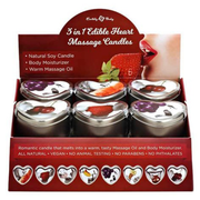 Edible heart-shaped massage candles in a display box with fruit imagery.