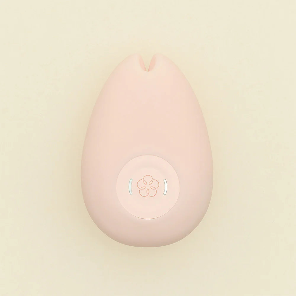 Pink teardrop-shaped vibrator with a flower-like button.