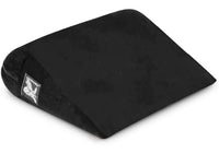 Black wedge-shaped foam positioning pillow with a logo patch.