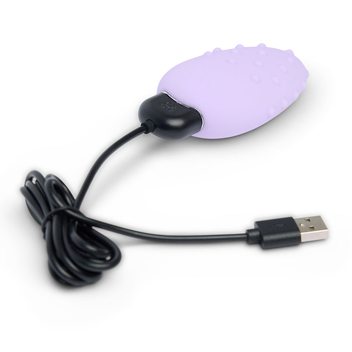 A purple clitoral vibrator with a USB charging cable.