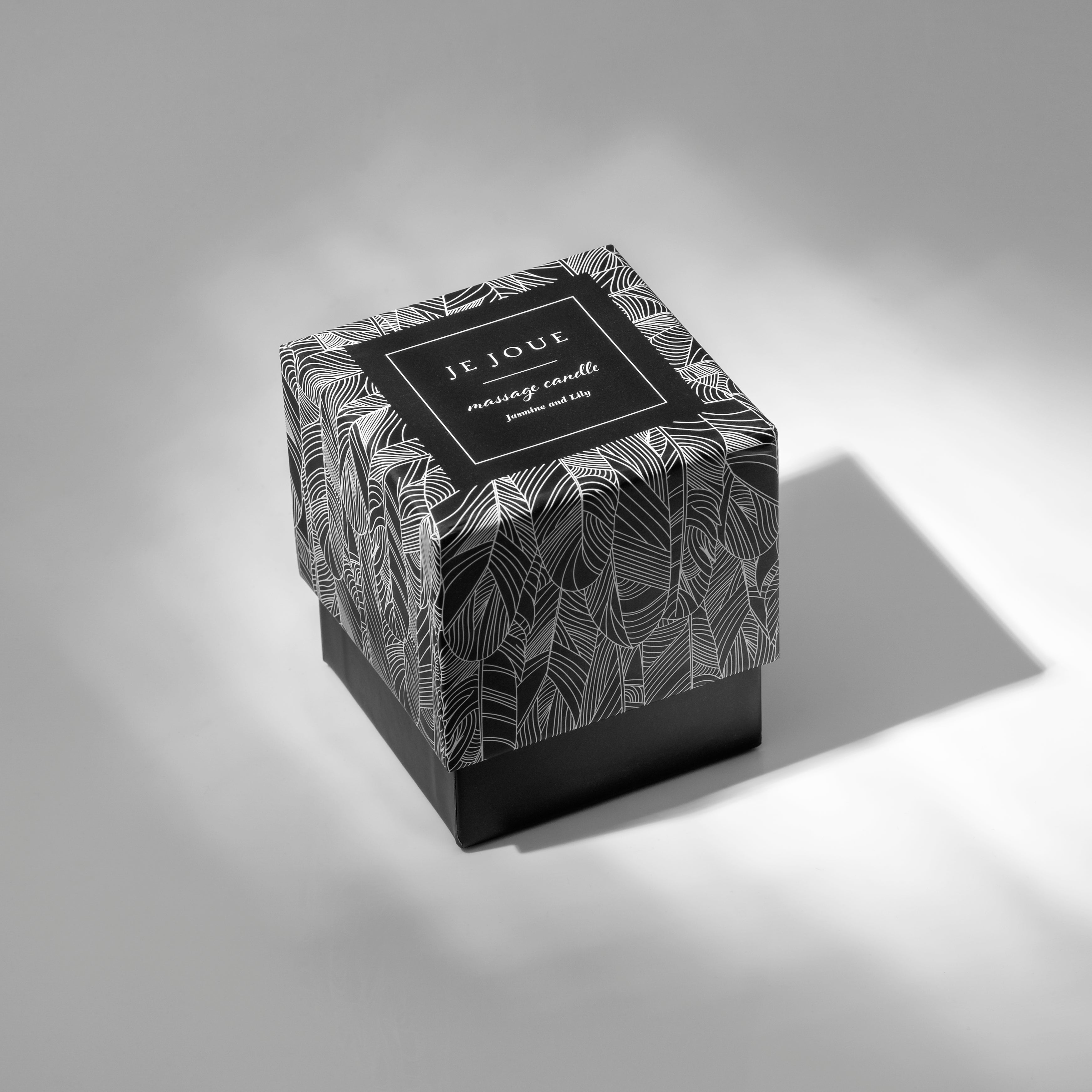 Jasmine and Lily Je Joue massage candle in a black and white patterned box.