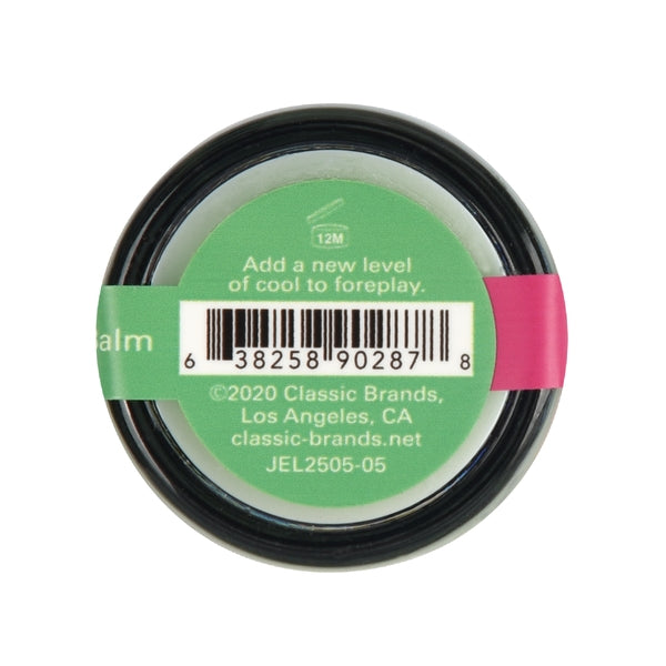 A round balm container with a green label showing a barcode and text.