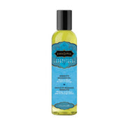 Kama Sutra Serenity massage oil in a clear bottle with a black cap.
