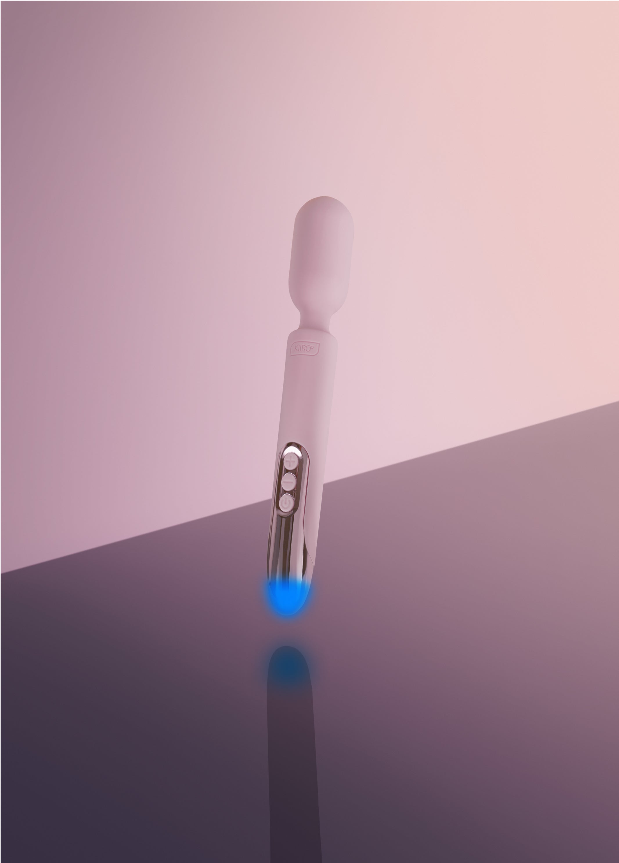 A pink Kiiroo ProWand vibrator with a blue light at the tip.