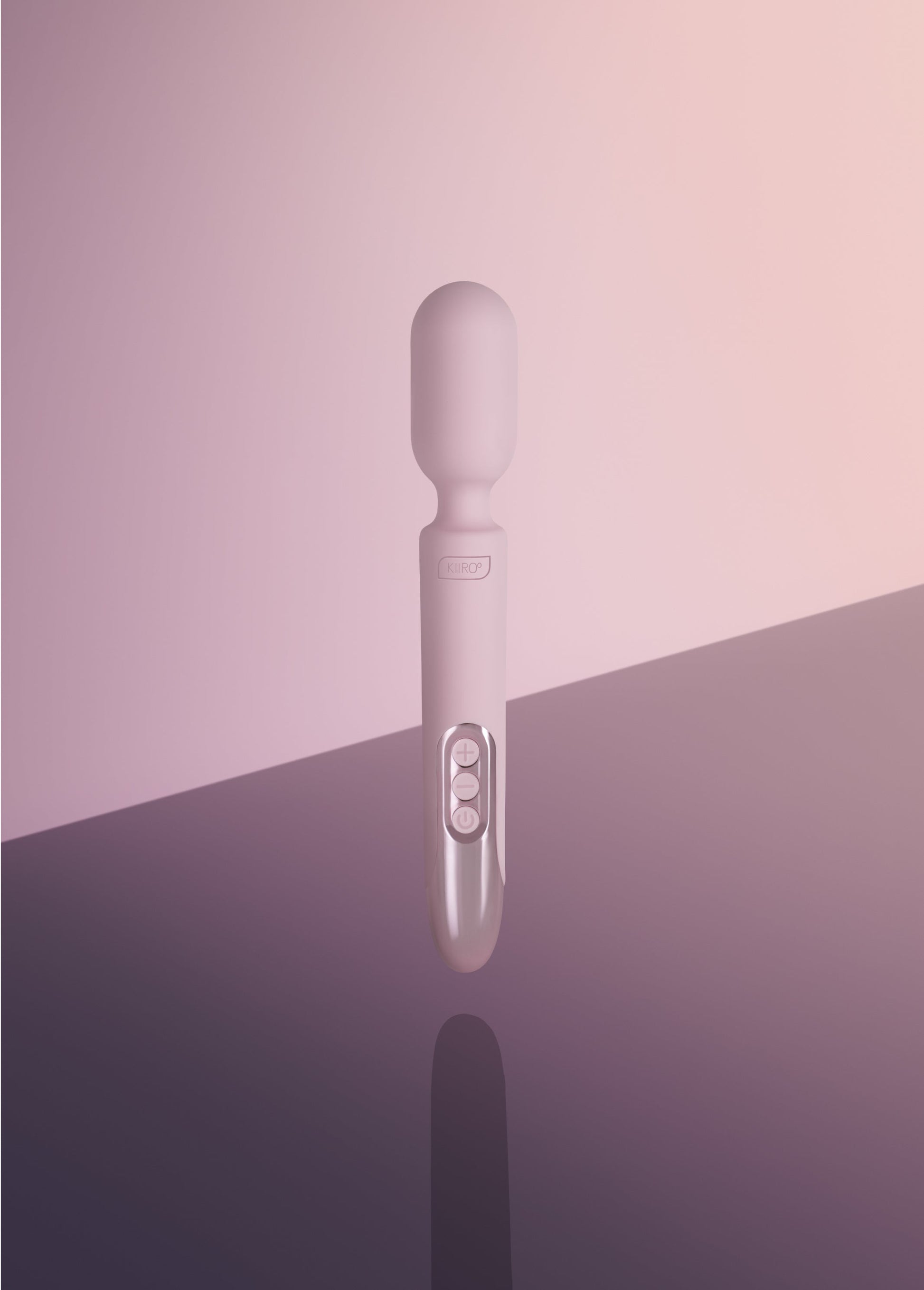 A pink Kiiroo wand vibrator with three buttons and a logo.
