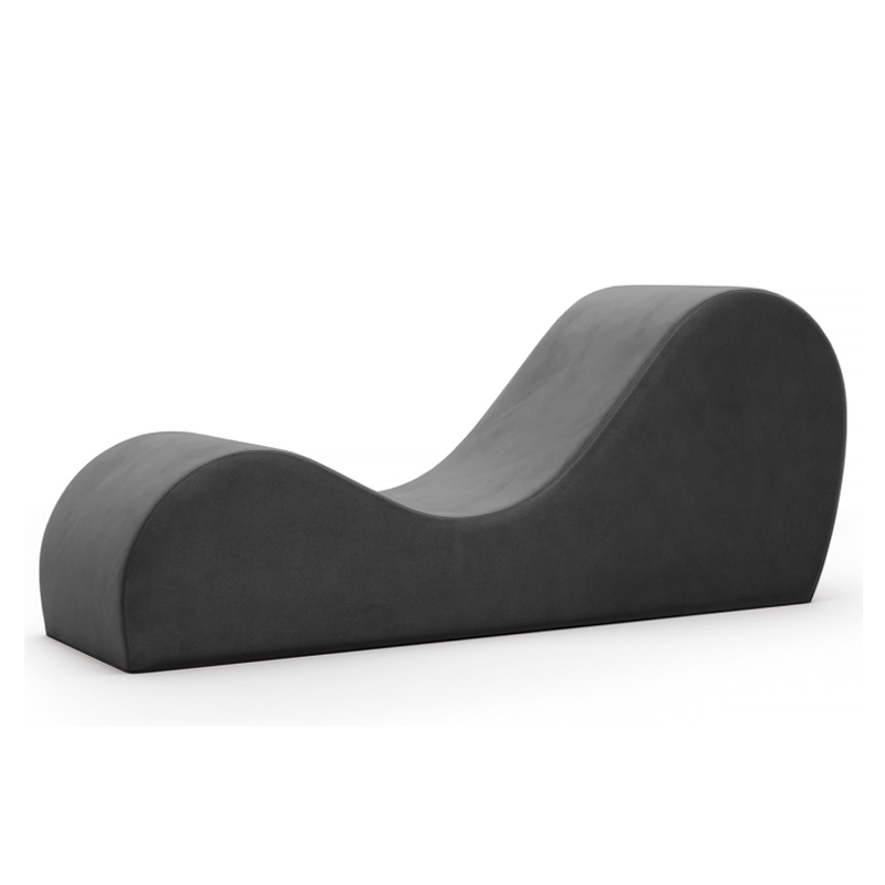 Black micro-velvet ergonomic chaise lounge with a curved design.