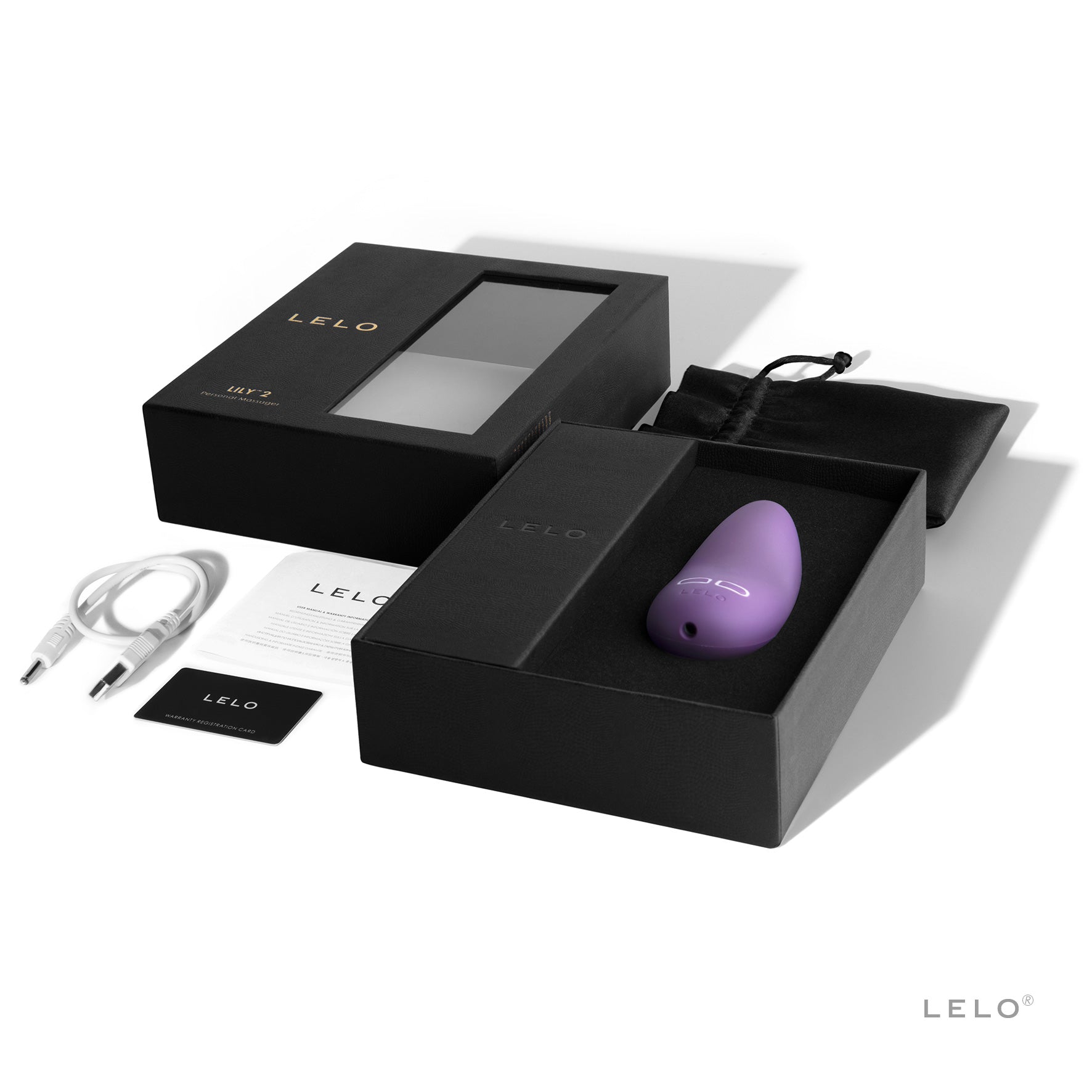 A lavender LELO Lily 2 vibrator with its packaging and accessories.