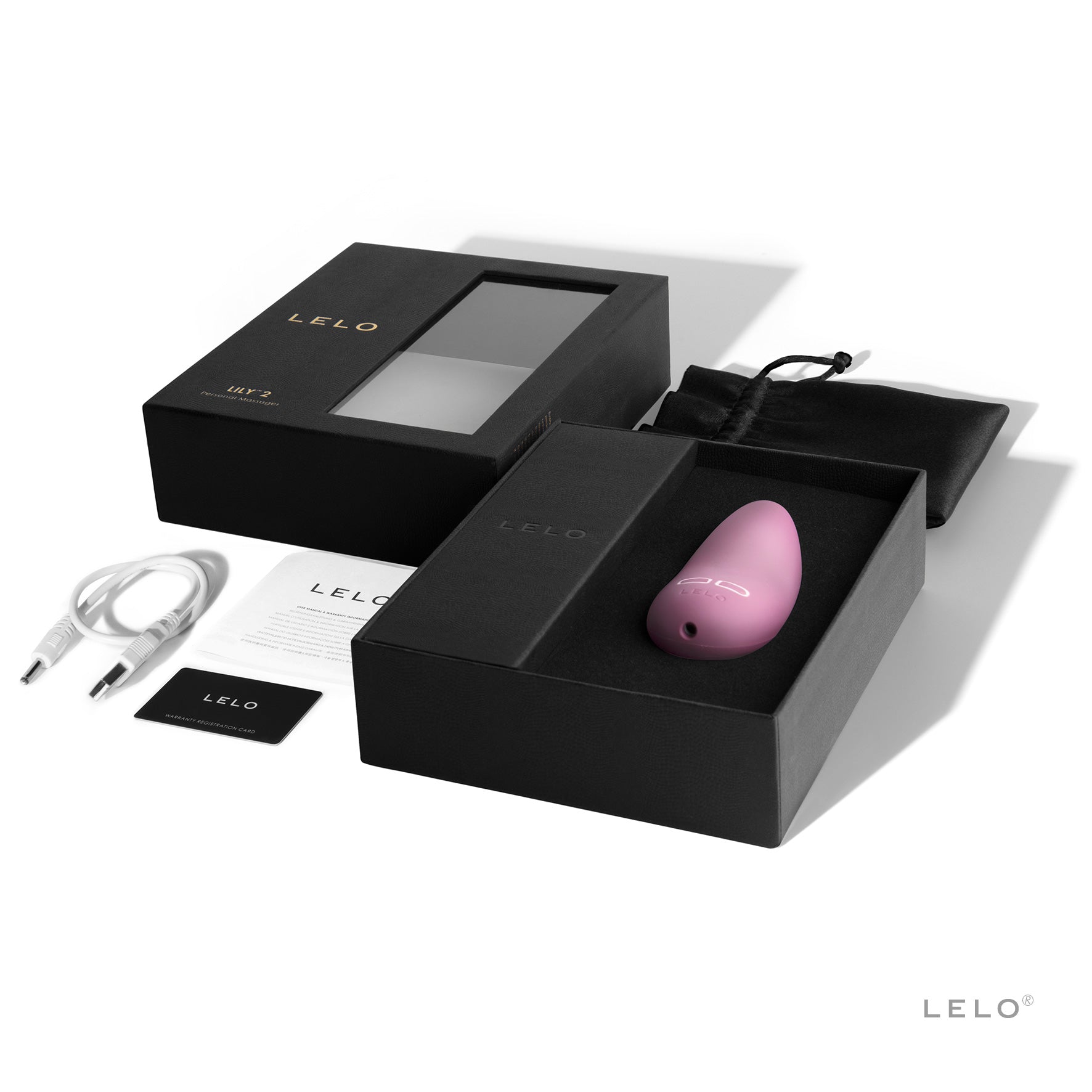 A pink LELO LILY 2 vibrator with its box, charging cable, and manual.