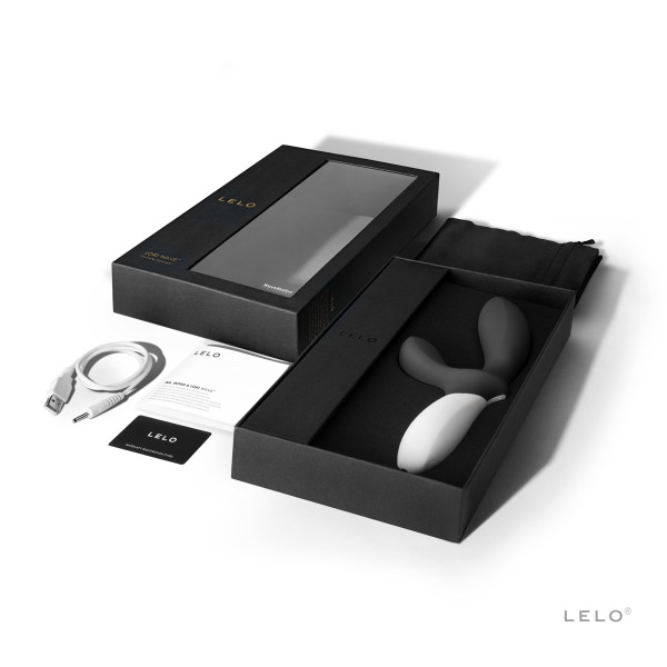 Loki Wave prostate massager in black and white silicone, with charging cable and packaging.