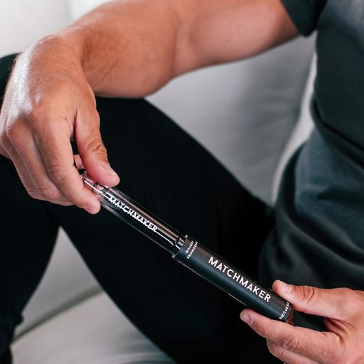 A man holds a black tube labeled "MATCHMAKER" with a clear vial inside.