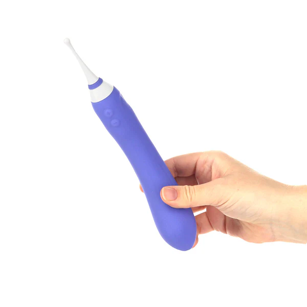A hand holds a purple dual-ended vibrator with a white tip.