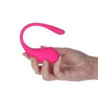 A pink Lovense Lush 3 app-controlled vibrating egg held in a hand.
