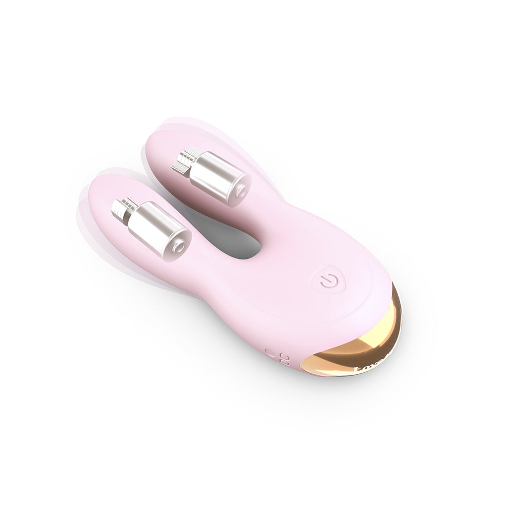 Pink dual motor silicone clitoral vibrator with gold accents.