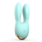 Mint green dual motor silicone clitoral vibrator with ear-shaped stimulators.