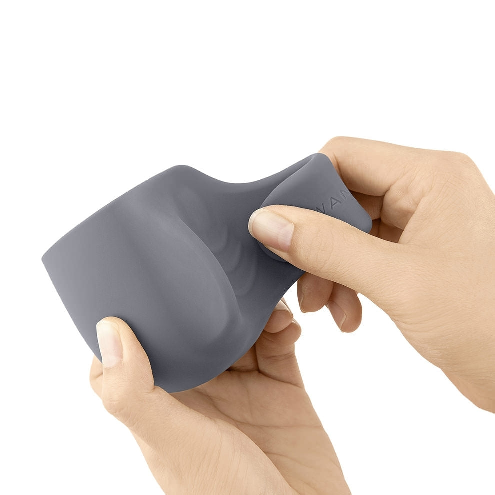 Gray silicone loop attachment for a wand, held by two hands.