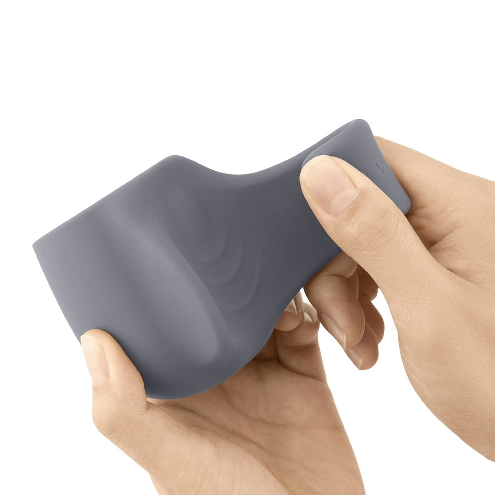 Gray silicone wand attachment and cock ring held by hands.