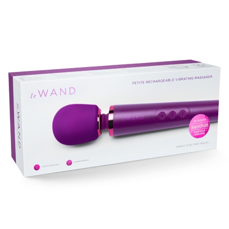 A dark cherry Le Wand petite rechargeable vibrating massager in its box.