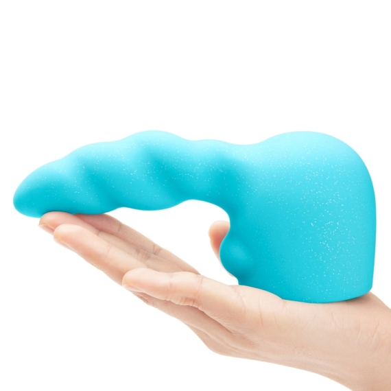 A turquoise silicone massager with a textured surface rests on a hand.