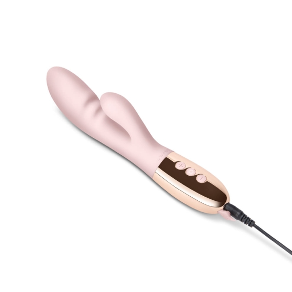 A pink rabbit vibrator with rose gold accents and a charging cable.