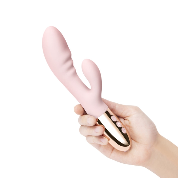 Rose gold rabbit vibrator held in a hand.