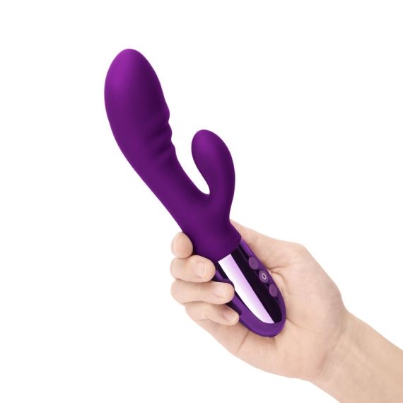 A purple rabbit vibrator with a curved shaft and two smaller ears, held in a hand.