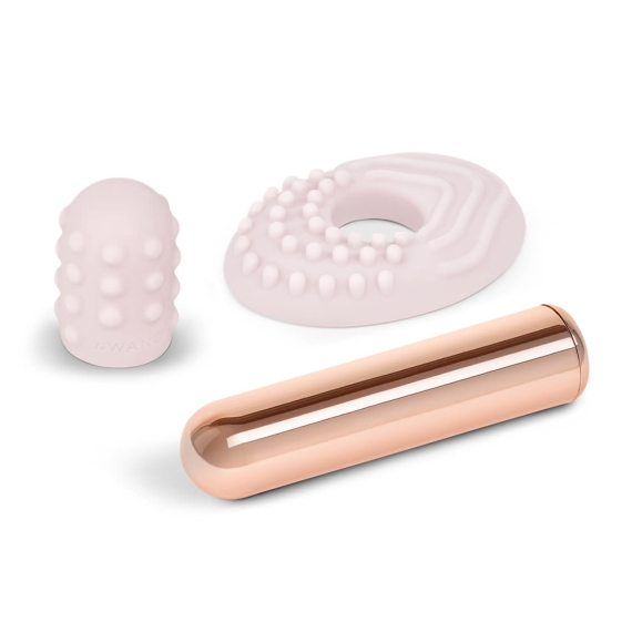 Rose gold bullet vibrator with textured pink silicone attachments.