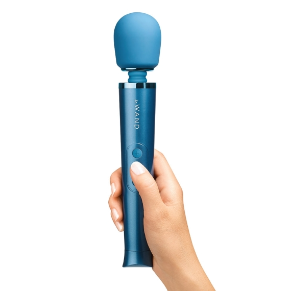 A blue rechargeable wand vibrator held in a hand.