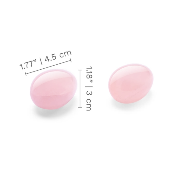 Two pink rose quartz yoni eggs with dimensions indicated.