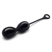 Black obsidian yoni eggs with a retrieval loop on a white background.
