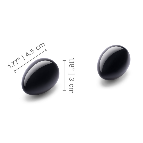 Two black obsidian yoni eggs with size dimensions.