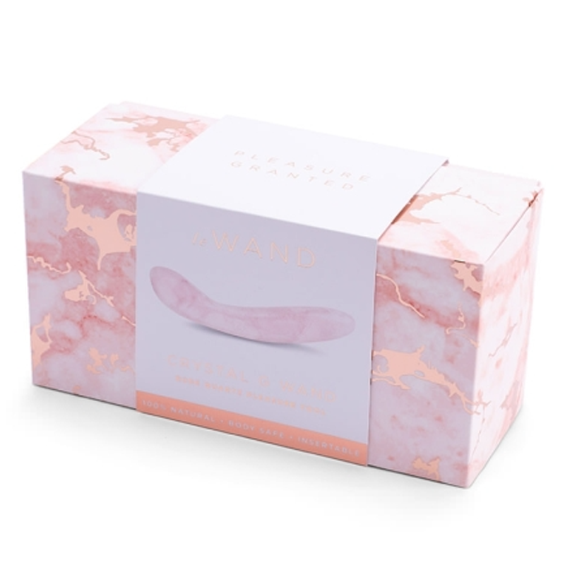 A pink crystal wand with a marble patterned box.