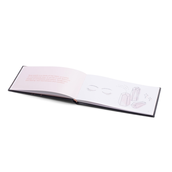 Open book with text about rose quartz and a drawing of eyes and crystals.