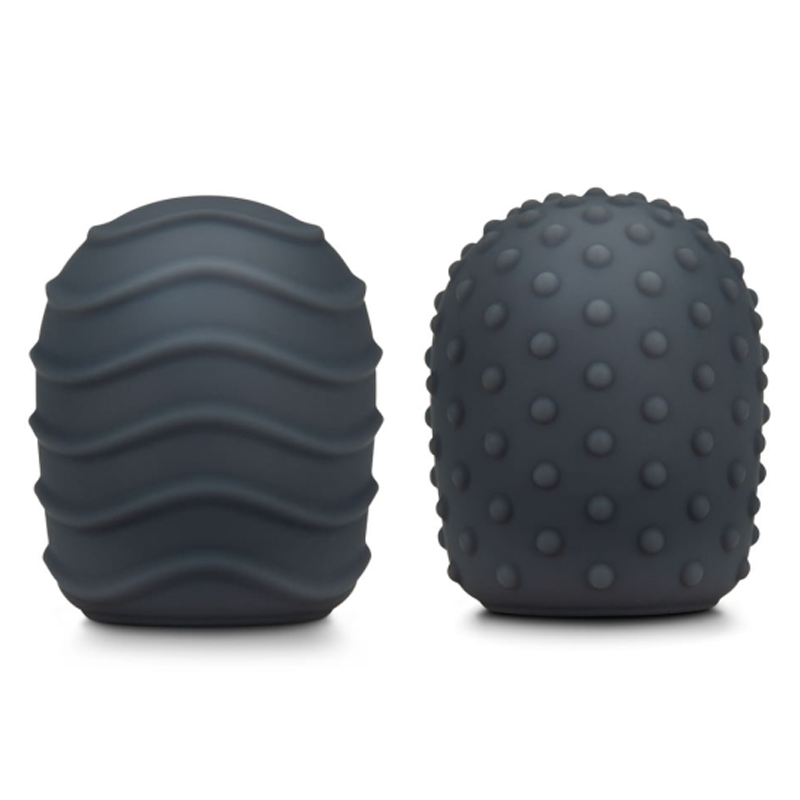 Two dark grey silicone texture covers for a massager, one with wavy lines and one with raised dots.