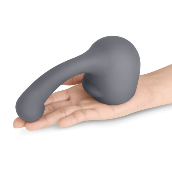 A grey silicone wand attachment with a curved tip rests on a hand.
