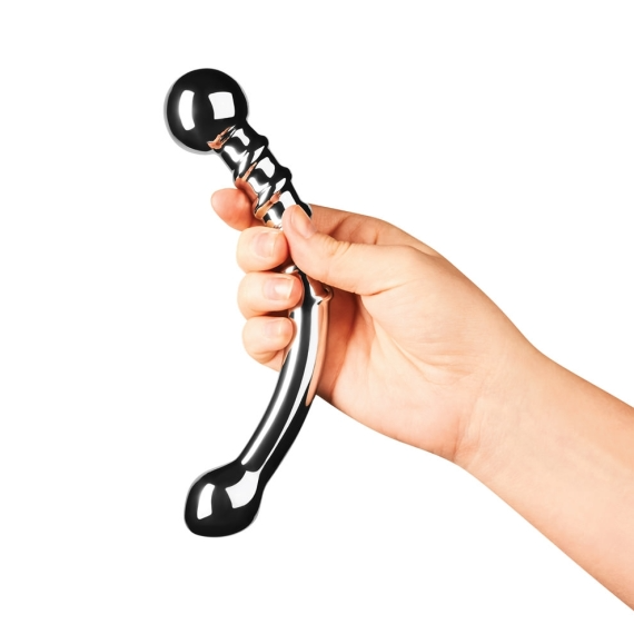 A hand holds a curved, silver stainless steel wand with a bulbous end.