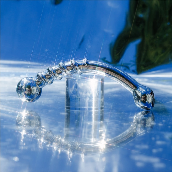 Curved stainless steel wand with a bulbous, ridged end and a shaped tip.