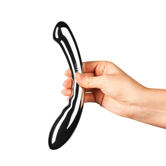 A hand holds a curved, double-ended stainless steel massager.