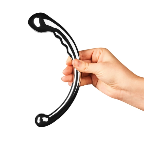 A hand holds a curved, polished stainless steel wand with a bulbous end.