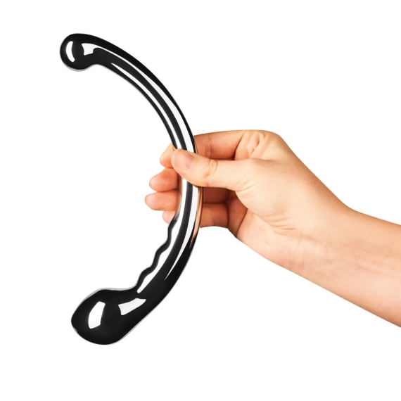 A hand holds a curved, polished stainless steel wand with a bulbous end.