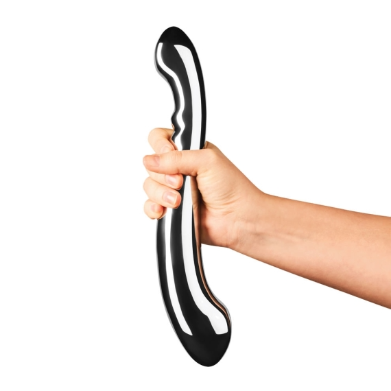 A hand holds a curved, polished stainless steel body wand.