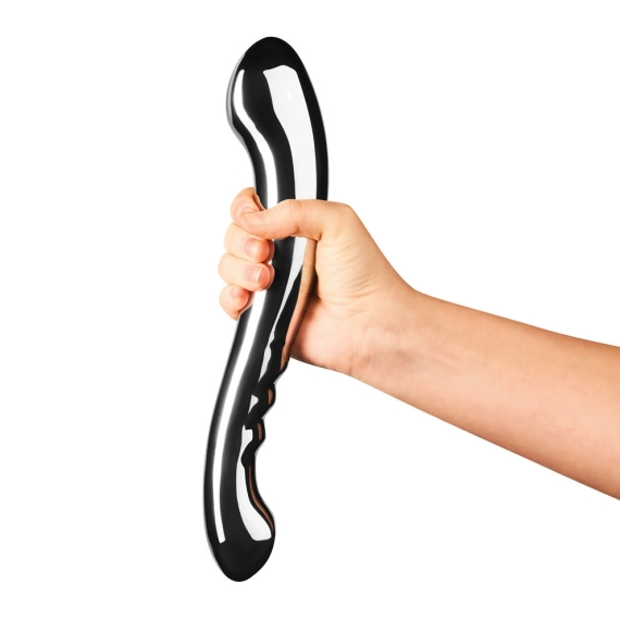 A hand holds a curved, polished stainless steel body wand.
