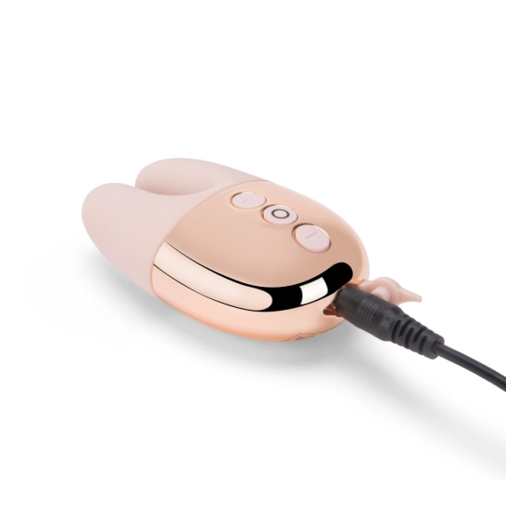 Rose gold rechargeable rabbit vibrator with charging cable.