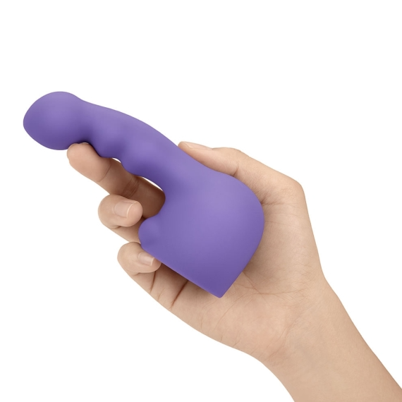 Purple silicone wand attachment held in a hand.