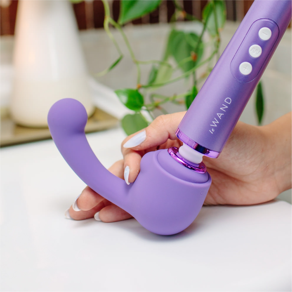 A purple silicone wand attachment with a curved head.
