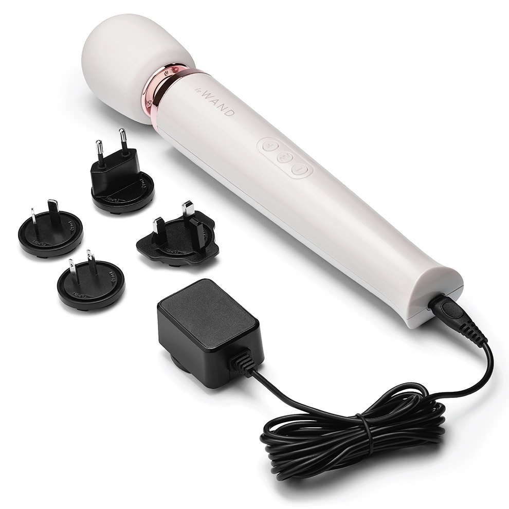 White rechargeable wand massager with charging accessories.