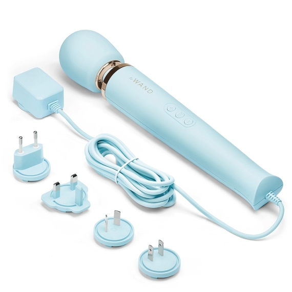 A light blue plug-in wand massager with multiple power adapters.