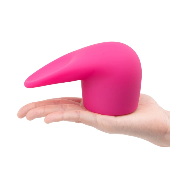 A pink silicone wand attachment with a tongue-like tip rests on a hand.