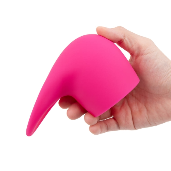 A hand holds a bright pink, flexible silicone wand attachment with a pointed tip.